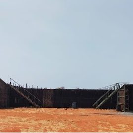 Ground-level wildlife containment facility with secure enclosures